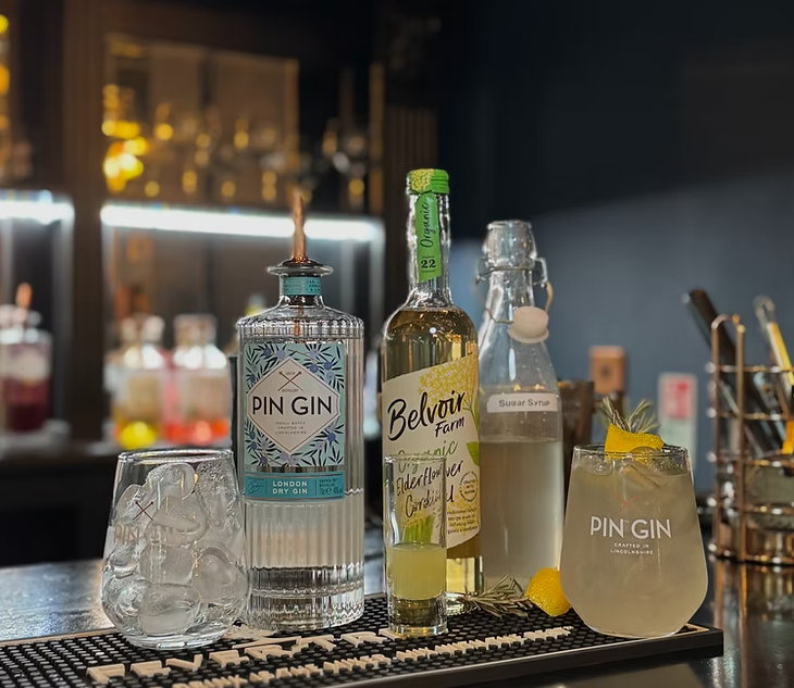 Celebrate National Cocktail Day with a Pin Gin Collins at The Auction House!